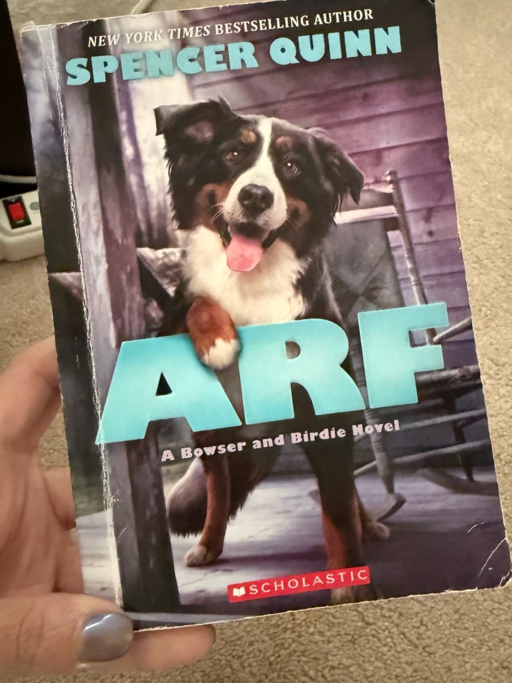 Scholastic Paperback with Teal Title and Purple Backdrop